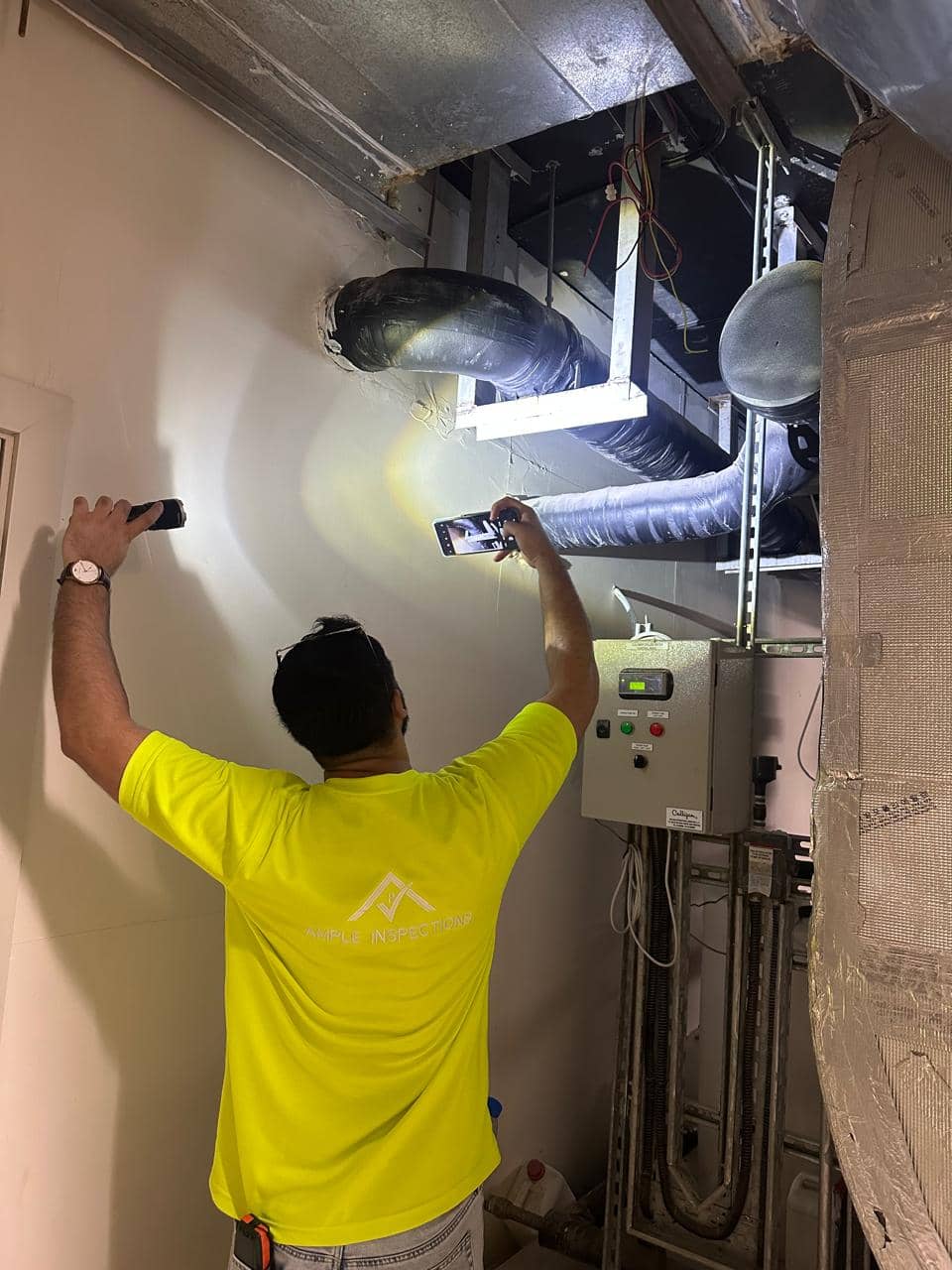 Inspector reviewing MEP systems during snagging inspection